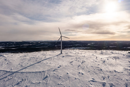 Aerial drone view of a lonely wind turbine on a fell, in cloudy arcticLaplandの写真素材