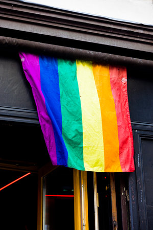 A beautiful shot of LGBTQ flags on a street buildingの写真素材