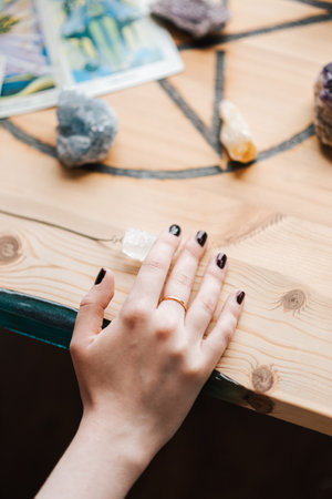 A vertical shot of Caucasian female hand on the table with stones in art studio in the UKの写真素材