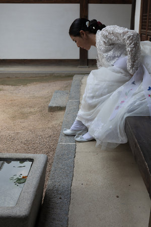A closeup of a South Korean bride putting her shoes onの写真素材