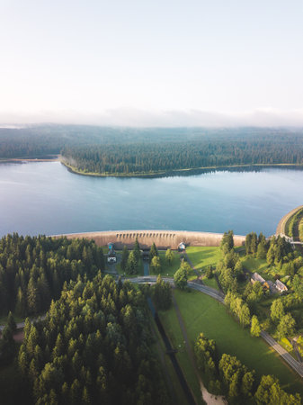 Golden light covers a big dam in germany at sunriseの写真素材