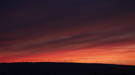 A mesmerizing sunset view over the land with wind turbines