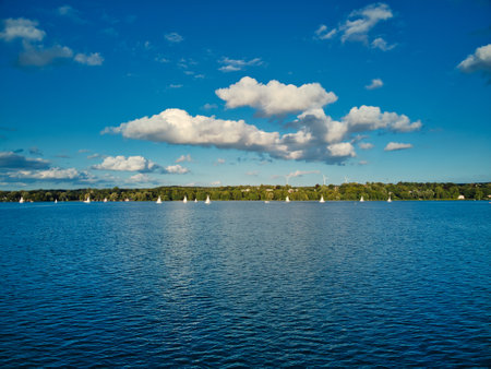Sailboat on lake Starnberg. Munich residents and vacationers sail and relax on the idyllic mountain...