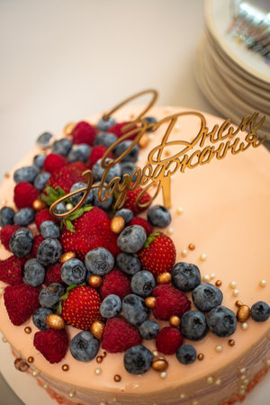 A beautiful shot of a cake decorated with raspberry and blueberryの写真素材