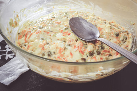 A closeup shot of a delicious dish in a glass bowl with a metal spoonの写真素材