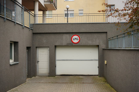 A white metallic gate and an LPG sign on the upper side of the wallの写真素材