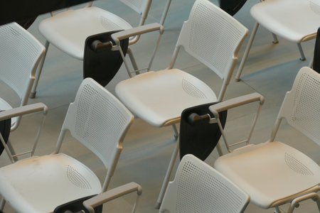 The rows of white seats in a conference room.の写真素材