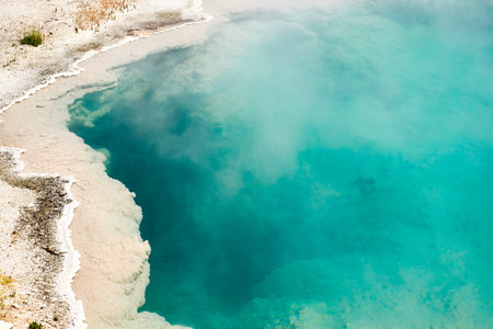 The crystal clear hot springs on a sunny day in Yellowstone National Park, Wyoming, the USの写真素材