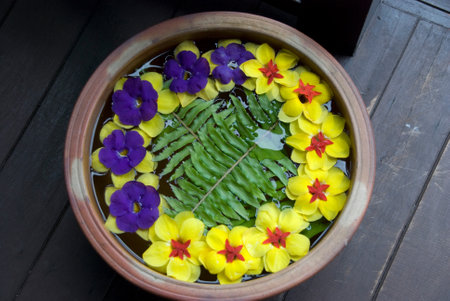 Beautiful flower arrangement in pot with yellow and purple flowers