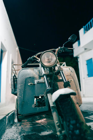 An old motorbike in Astypalaia Town, Santorini at night
