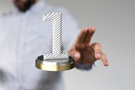 A 3d rendering of a white striped first place award on silver and golden mixed surfaceの写真素材