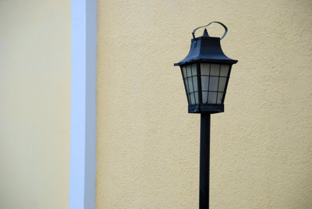 Street lantern illuminated with sunlight, artificial lighting in urban city, detail of city...