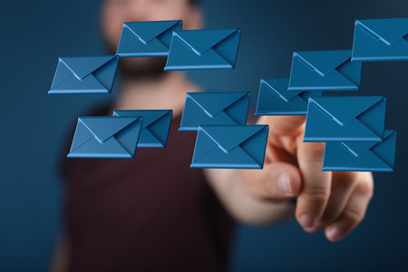 A man tapping on a 3D rendering of email icons - online communication conceptの写真素材