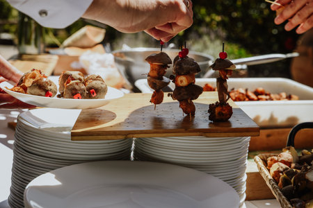 A closeup shot of barbecue with skewers served on a wooden board