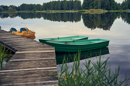 A lake with the trees in the background and a boat