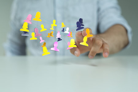 A businessman tapping on 3D rendered people - global networking and connection conceptの写真素材