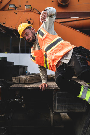 A vertical closeup of the worker jumping from the vehicle.