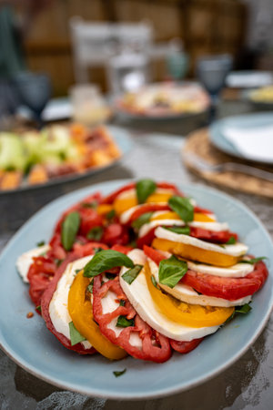 A vertical shot of Caprese salad with mozzarella, heirloom tomatoes, and basilの写真素材