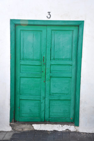 Green door and white facade of Spanish house on balearic island Lanzaroteの写真素材