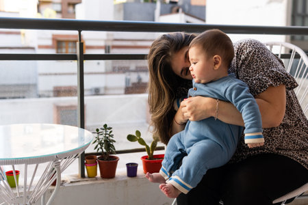 A cute Hispanic child and mother on a balconyの写真素材