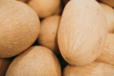 A closeup shot of a pile of yellow melonsの写真素材