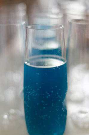 A closeup shot of a blue drink in the glassの写真素材