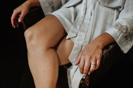 A closeup shot of a woman wearing a white dressing gownの写真素材