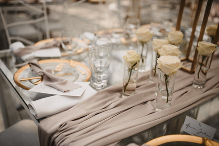 A closeup of the classy and elegant table settings of an outdoors wedding receptionの写真素材