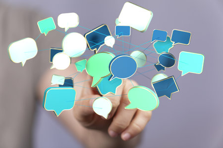 A closeup of a man pointing into 3D rendered d speech bubbles teamwork connectionの写真素材
