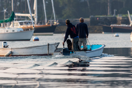 A selective of fishermen in a boat going fishing in the morningの写真素材