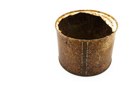 A closeup shot of a rusty food tin can from the Spanish civil war isolated on white backgroundの写真素材