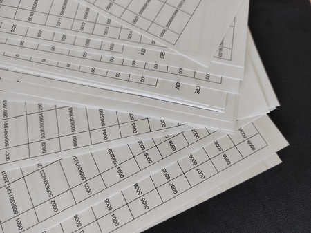 A pile of papers with many numbers printed on them