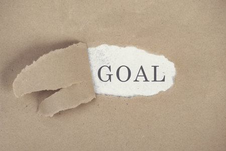 The word goal is standing on a white background, ripped textured paperの写真素材