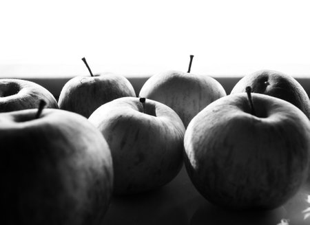 A closeup shot of apples isolated on a white background in grayscaleの写真素材