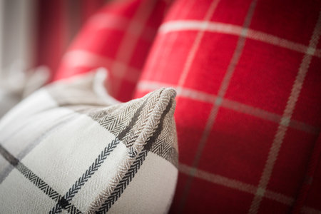 A closeup of white and red square pattern pillowsの写真素材