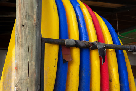 A closeup shot of colorful surfing boards set up under the sun