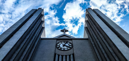 A low angle shot of the Church of Akureyri under a cloudy skyの写真素材