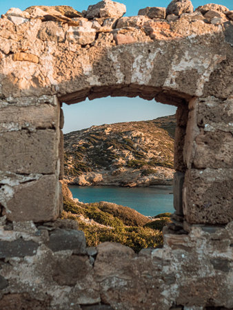 A vertical shot of an arch stone wall through tranquil river under sunlightの写真素材