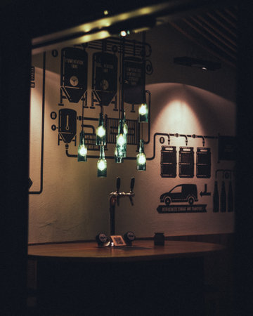 A vertical shot of an empty bar with hanging bottles and low lighteningの写真素材