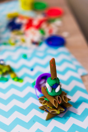A vertical shot of a handmade piece with pasta and colorful clay in Poznan, Polandの写真素材