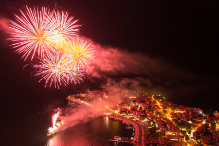 The beautiful bright fireworks in the night sky above the city.の写真素材