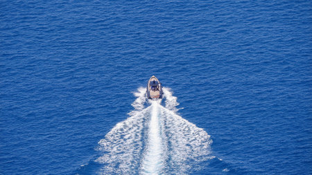 A boat in the green clear sea during the daytime