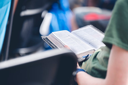 A Christian person reading the Bible at a religious ceremony in a church