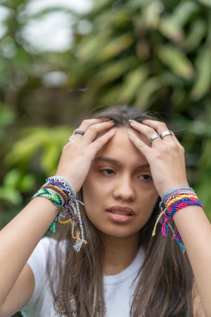 The rings and colorful stylish bracelets on girl's handsの写真素材