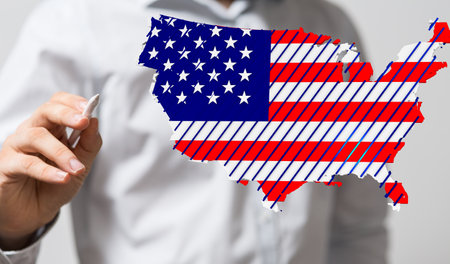 the male hand with 3D render of America map flag nation with stars and stripesの写真素材