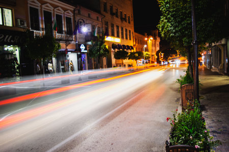 A scenic view of a street with buildings and nature during a nighttimeの写真素材