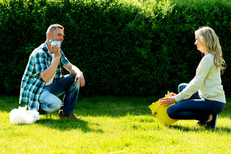 A romantic Polish couple playing on green grass outdoorsの写真素材