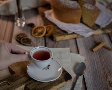 A cup of black tea with a freshly baled biscuit on a wooden tableの写真素材