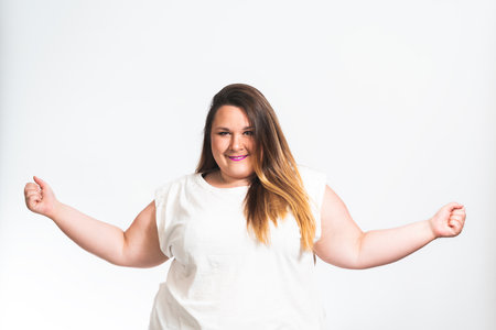 A beautiful attractive chubby overweight female Caucasian smiling model posing for a photoshootの写真素材