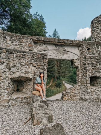 Front view of stylish young woman in front of old outpost ruin in Vuzenica, Slovenia.の写真素材